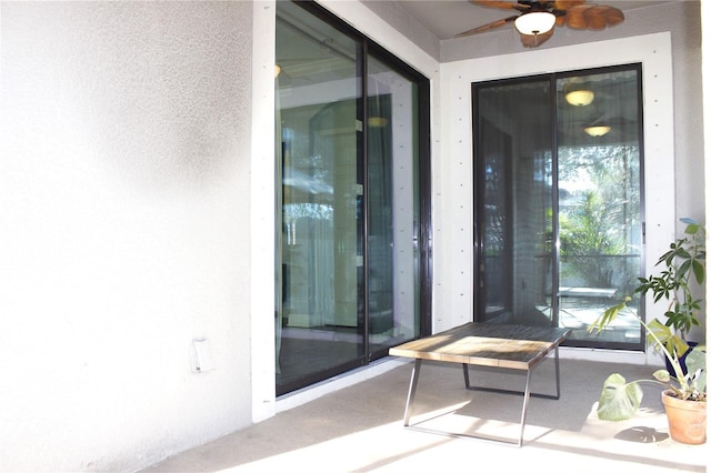 property entrance with a patio and ceiling fan