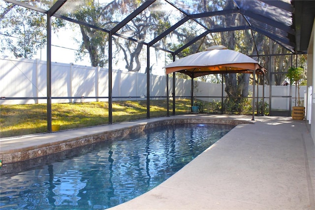 view of pool featuring a gazebo, a patio, and glass enclosure