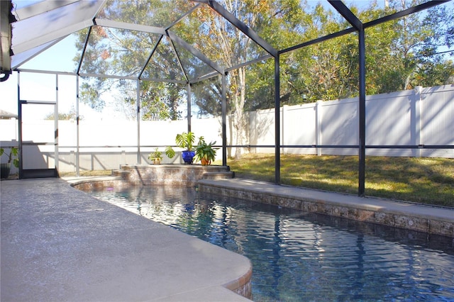 view of swimming pool featuring glass enclosure