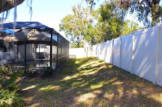 view of yard featuring glass enclosure