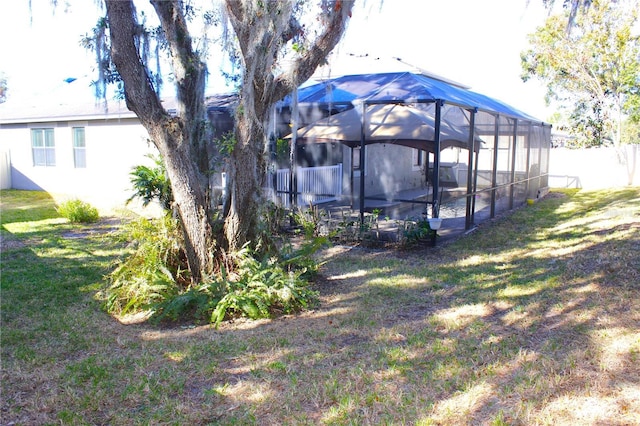 view of yard with glass enclosure