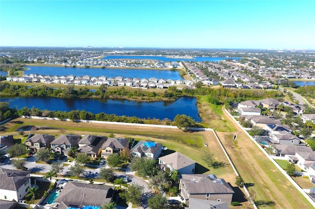 birds eye view of property with a water view and a residential view