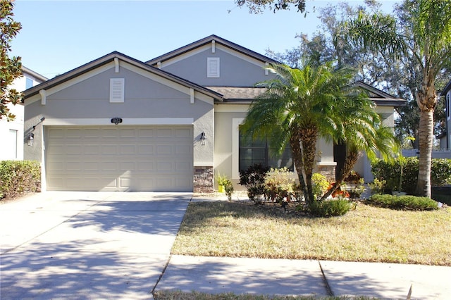 ranch-style home with a garage, concrete driveway, stone siding, and stucco siding