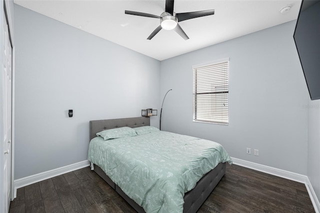 bedroom with wood finished floors, a ceiling fan, and baseboards