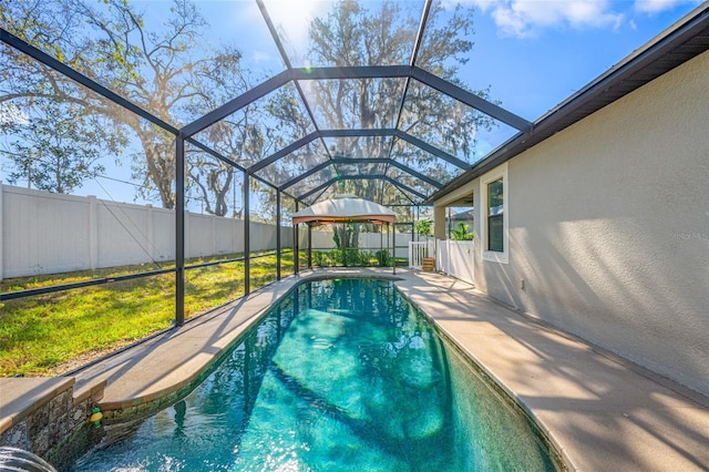 view of pool featuring a fenced in pool, glass enclosure, a patio area, and a fenced backyard