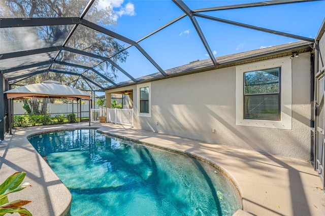 view of pool featuring glass enclosure, a patio area, fence, and a fenced in pool