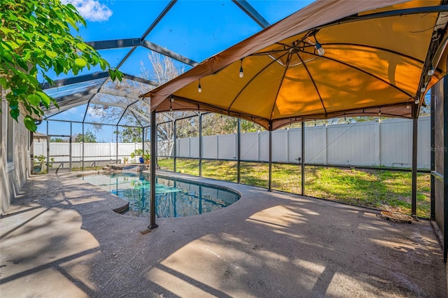 view of swimming pool featuring a patio, a fenced backyard, and a lanai