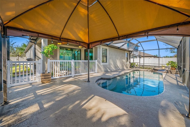 view of pool featuring a fenced in pool, glass enclosure, fence, and a patio