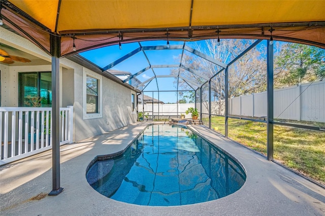 view of pool with a fenced in pool, glass enclosure, a fenced backyard, and a patio