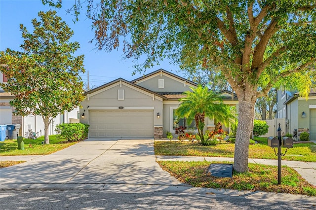 view of front of house featuring a garage, driveway, fence, and stucco siding