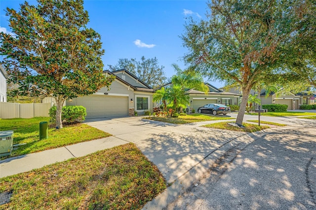 view of front of property featuring a garage, fence, a front lawn, and concrete driveway