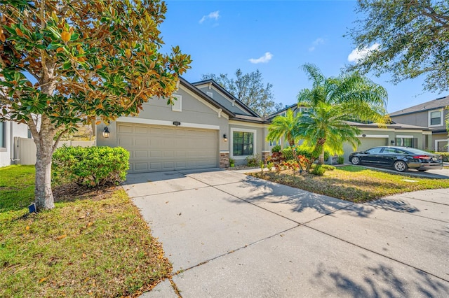 view of front of property featuring concrete driveway, an attached garage, and stucco siding