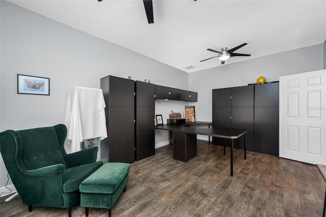 office featuring ceiling fan, a textured ceiling, and dark wood-style flooring