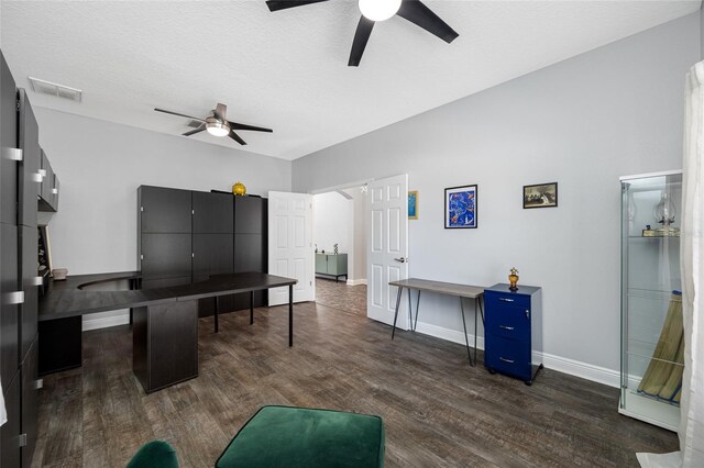 interior space featuring baseboards, visible vents, dark wood finished floors, ceiling fan, and a textured ceiling