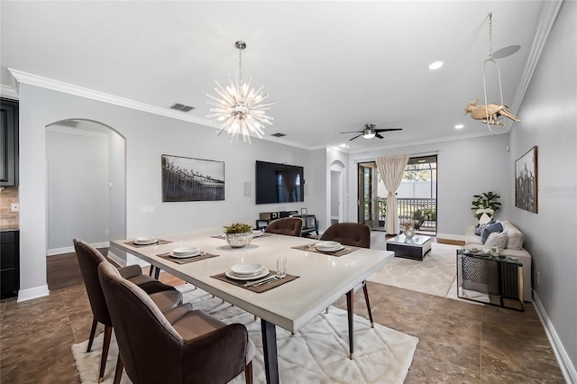 dining area with arched walkways, baseboards, and crown molding