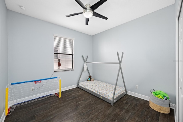 bedroom with a ceiling fan, baseboards, and wood finished floors