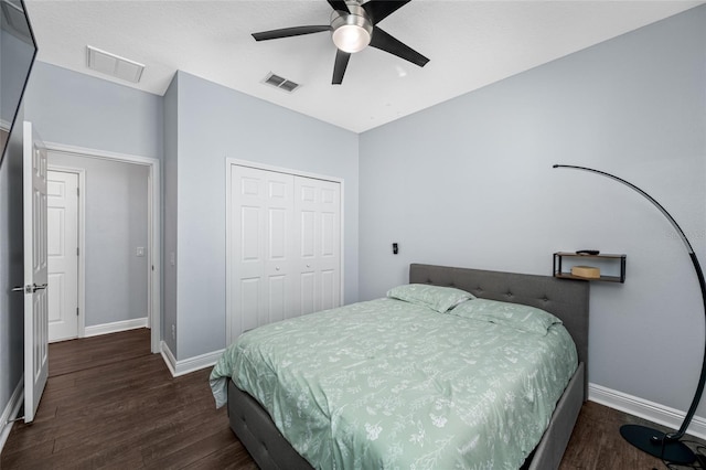 bedroom with baseboards, a closet, visible vents, and wood finished floors