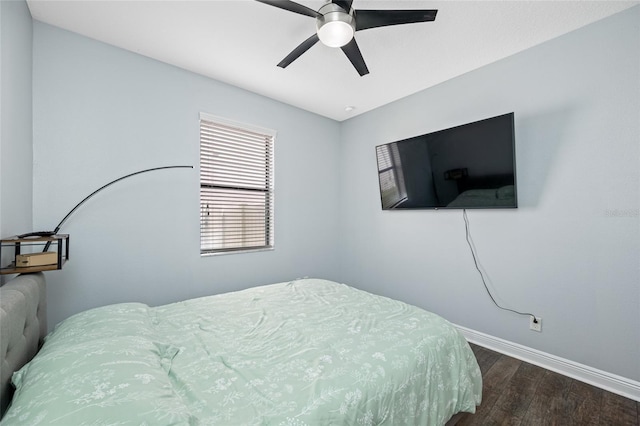 bedroom featuring wood finished floors, a ceiling fan, and baseboards