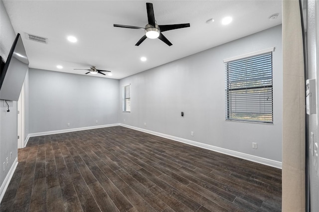 empty room with baseboards, visible vents, dark wood-style floors, ceiling fan, and recessed lighting