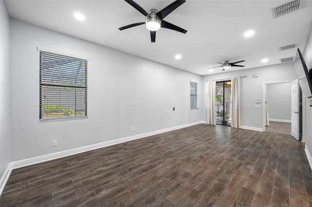 unfurnished room with dark wood-type flooring, recessed lighting, visible vents, and baseboards