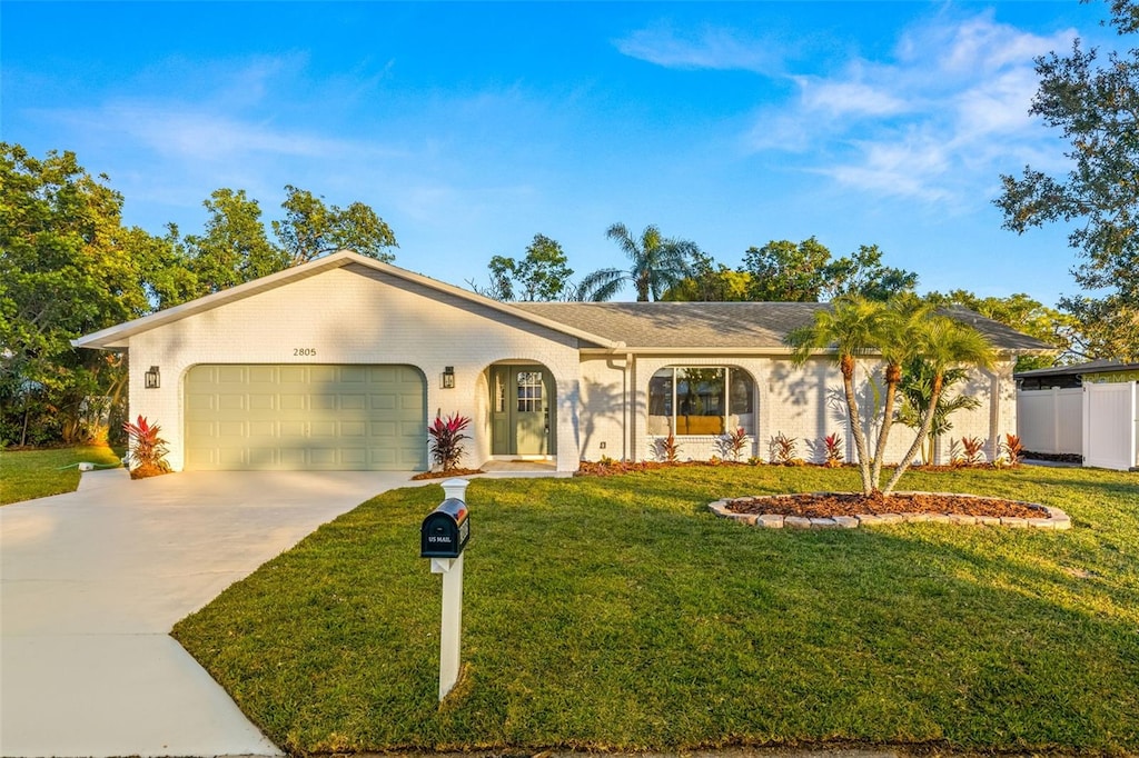 ranch-style house with a front yard and a garage