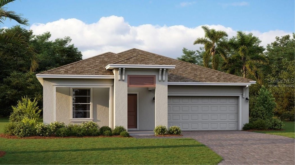 view of front facade with a garage and a front lawn