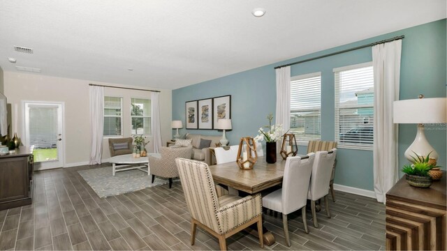 dining area featuring dark hardwood / wood-style flooring and plenty of natural light