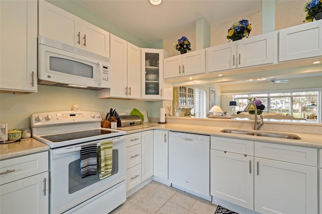 kitchen featuring white cabinets, ceiling fan, white appliances, and sink