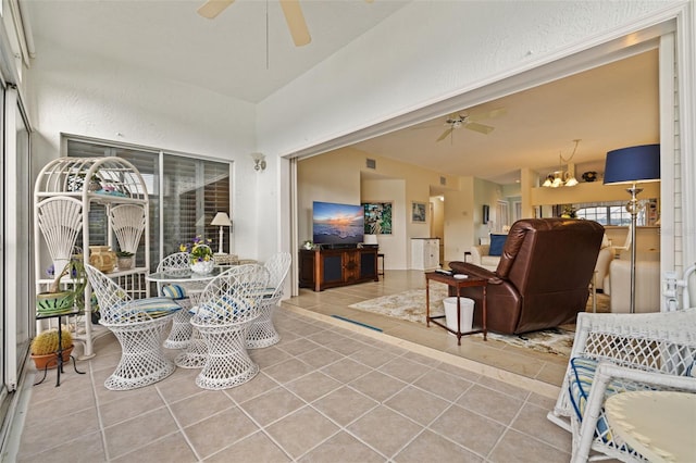 tiled living room with ceiling fan