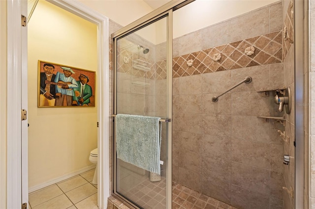 bathroom with tile patterned flooring, a shower with door, and toilet