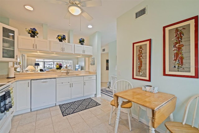 kitchen with dishwasher, white cabinetry, and sink