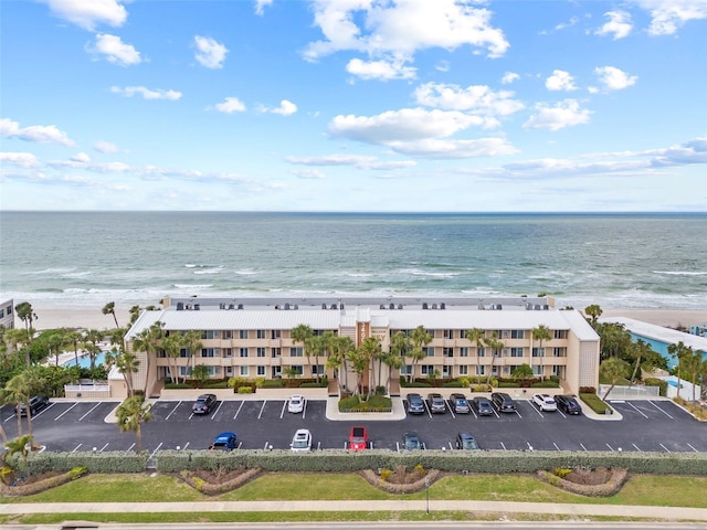 aerial view with a water view and a view of the beach