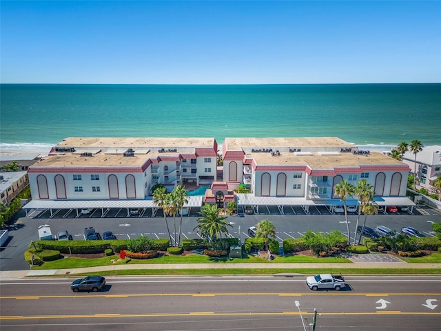 drone / aerial view with a water view and a view of the beach