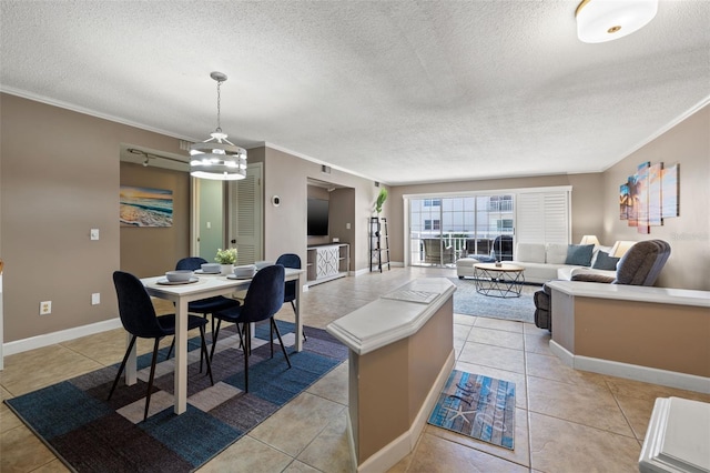 kitchen featuring a textured ceiling, decorative light fixtures, crown molding, and light tile patterned flooring