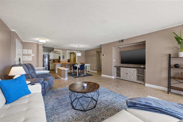 living room featuring light tile patterned floors, a textured ceiling, and ornamental molding