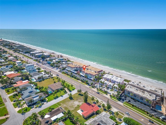 bird's eye view featuring a water view and a beach view