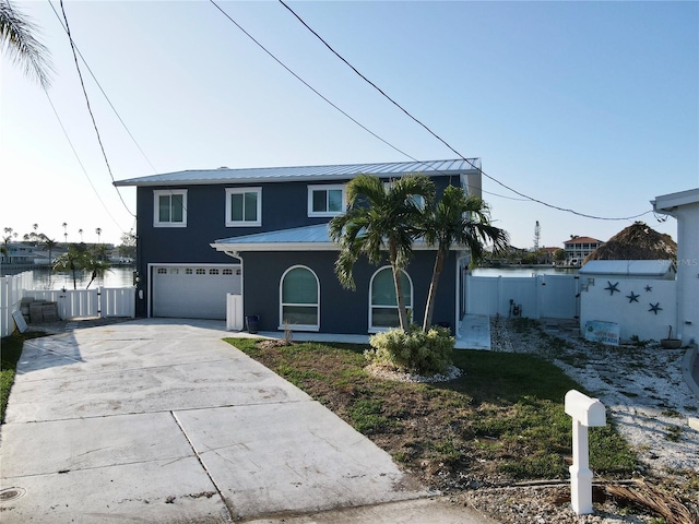 view of property featuring a water view and a garage