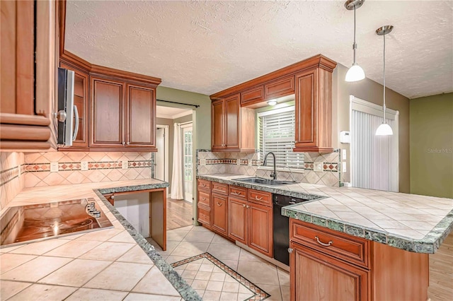 kitchen featuring dishwasher, sink, cooktop, kitchen peninsula, and decorative backsplash