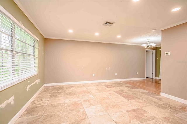 unfurnished room featuring crown molding and an inviting chandelier