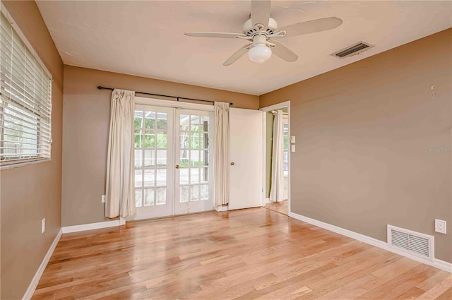 unfurnished room featuring ceiling fan, french doors, and light hardwood / wood-style floors