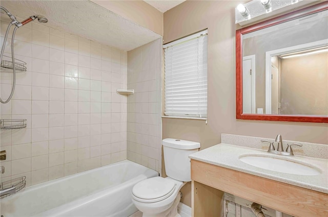 full bathroom featuring tiled shower / bath combo, toilet, and sink