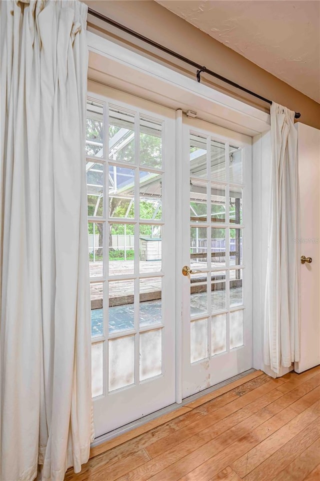 doorway to outside with light wood-type flooring