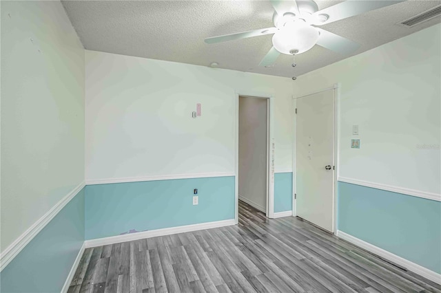 spare room featuring a textured ceiling, light hardwood / wood-style floors, and ceiling fan