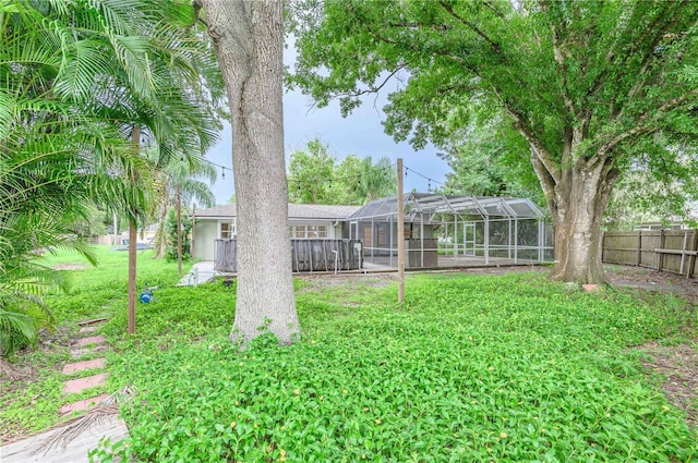 view of yard with glass enclosure