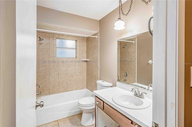 full bathroom featuring tiled shower / bath combo, tile patterned flooring, a textured ceiling, toilet, and vanity