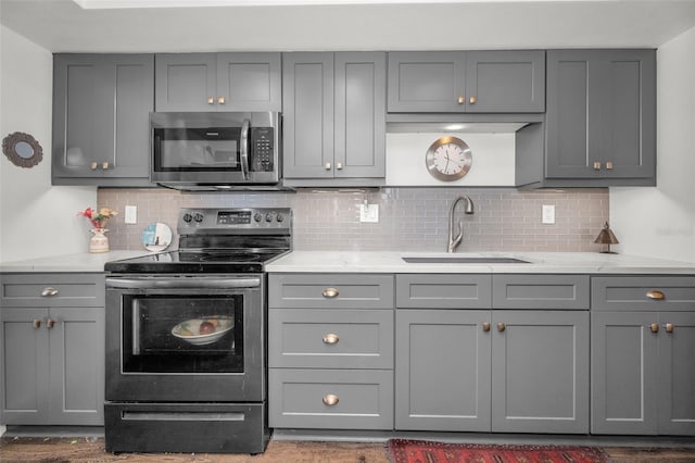 kitchen with electric range and gray cabinetry