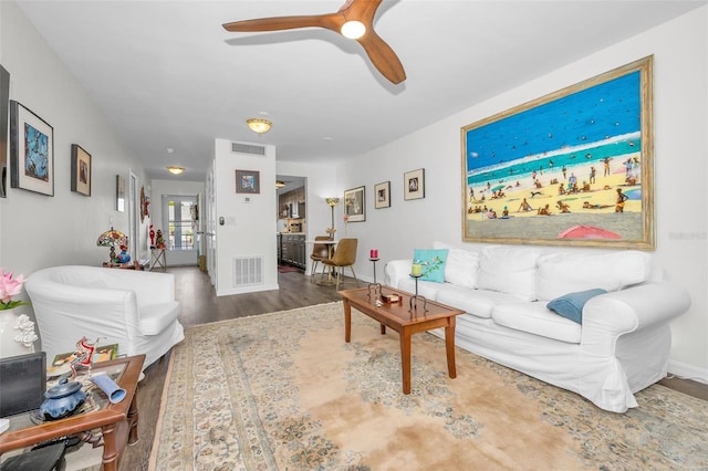 living room featuring ceiling fan and hardwood / wood-style floors