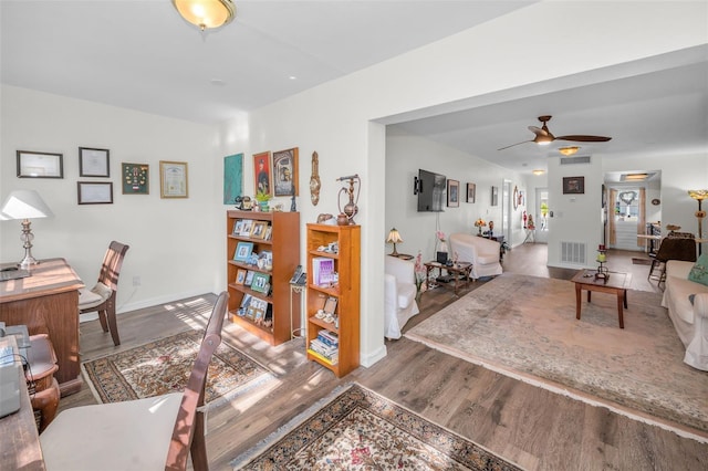 living room with hardwood / wood-style flooring and ceiling fan