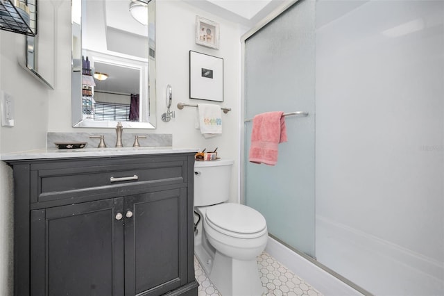 bathroom with vanity, an enclosed shower, and toilet