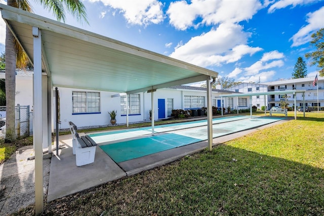 view of pool with a diving board and a lawn